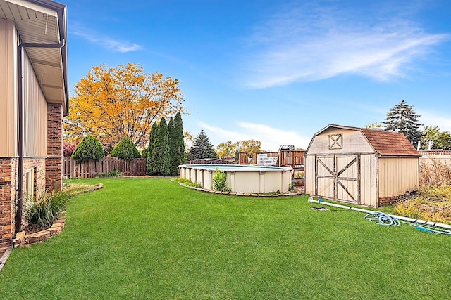 view of yard featuring a storage unit and a fenced in pool