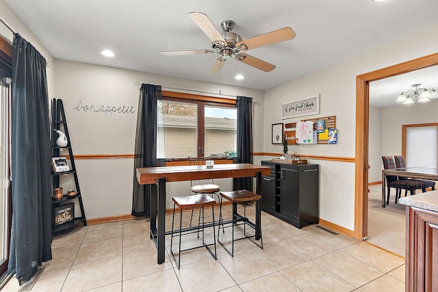 tiled dining room with ceiling fan