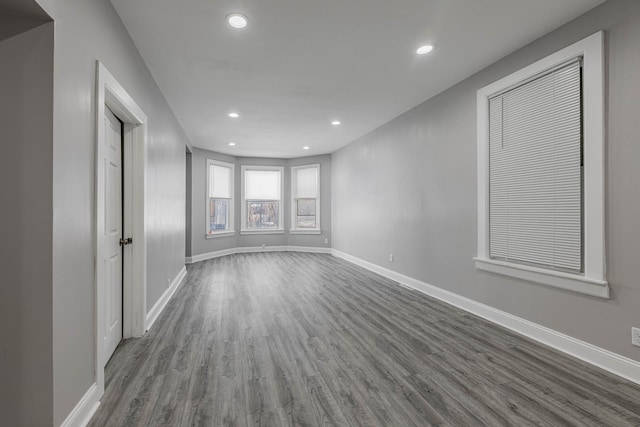 spare room with dark wood-type flooring