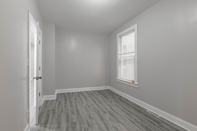 unfurnished room with light wood-type flooring