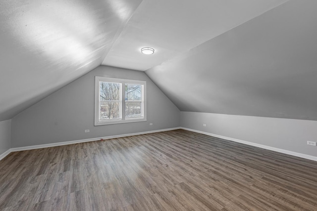 additional living space with lofted ceiling and dark hardwood / wood-style flooring