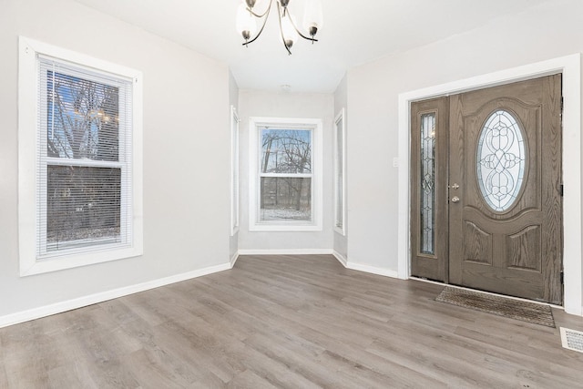 foyer featuring a chandelier and light wood-type flooring