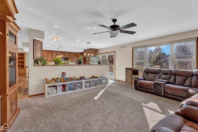 living room featuring ceiling fan and light colored carpet