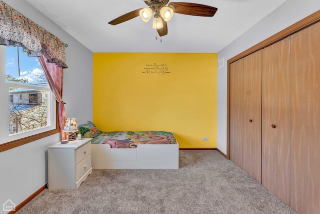 unfurnished bedroom with a closet, ceiling fan, and light colored carpet