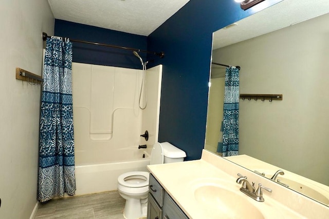 full bathroom with a textured ceiling, shower / tub combo with curtain, hardwood / wood-style flooring, toilet, and vanity