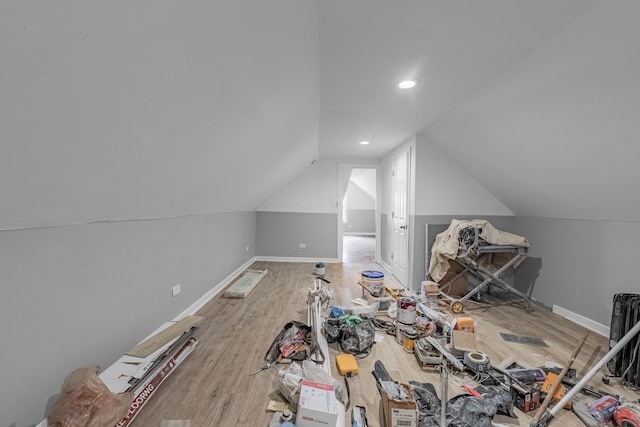 additional living space featuring lofted ceiling and wood-type flooring