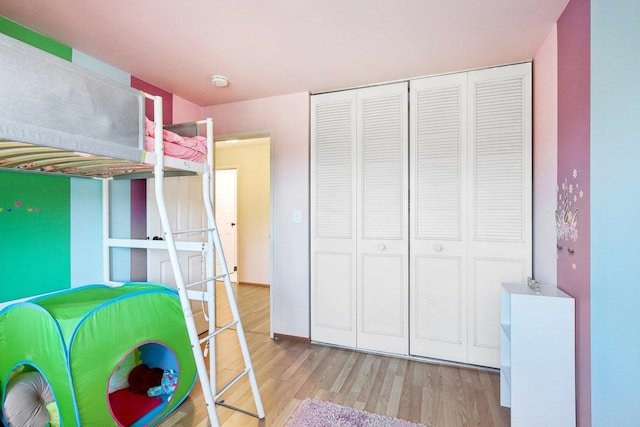 unfurnished bedroom with a closet and light hardwood / wood-style floors