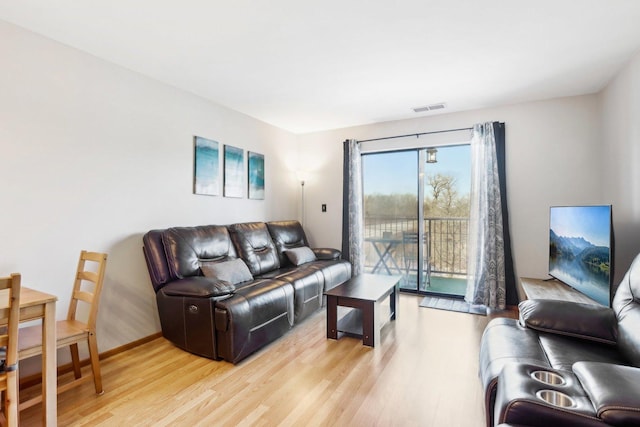 living room with light hardwood / wood-style flooring