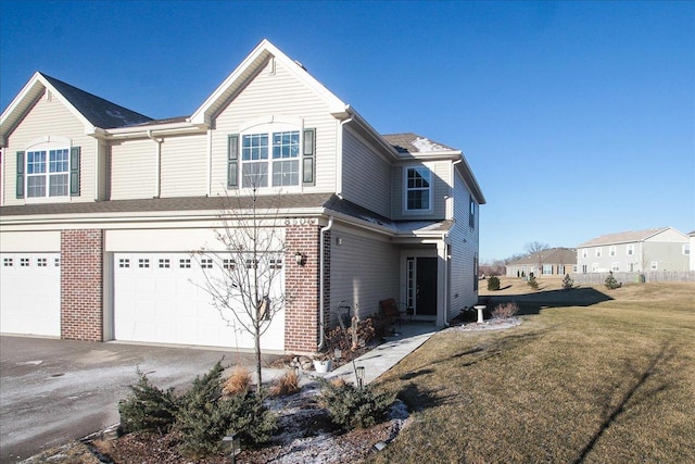 view of side of home with a yard and a garage