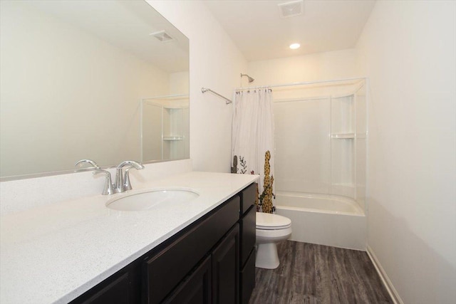 full bathroom with shower / bathtub combination with curtain, hardwood / wood-style floors, vanity, and toilet