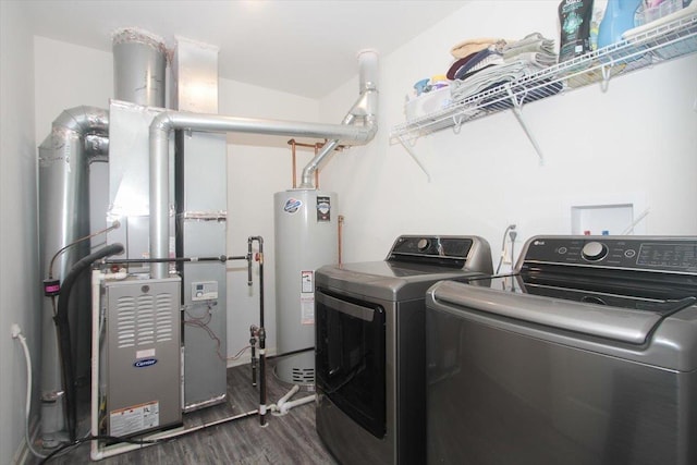 clothes washing area featuring water heater, independent washer and dryer, and dark wood-type flooring