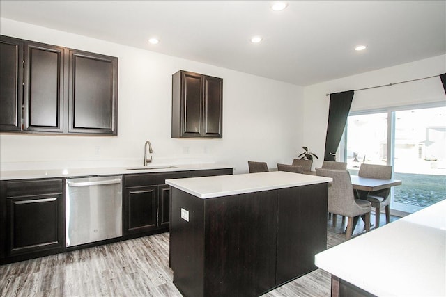 kitchen with sink, dishwasher, light hardwood / wood-style floors, and a center island