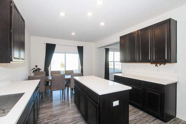 kitchen featuring sink, dark brown cabinets, a center island, and hardwood / wood-style floors