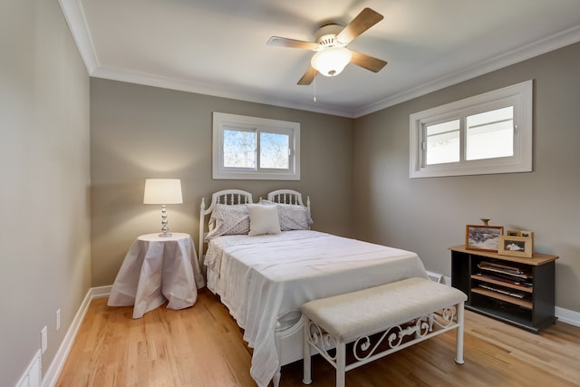 bedroom with ceiling fan, ornamental molding, and light hardwood / wood-style floors