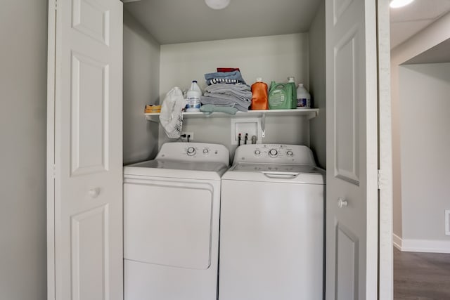 laundry room with independent washer and dryer and hardwood / wood-style floors