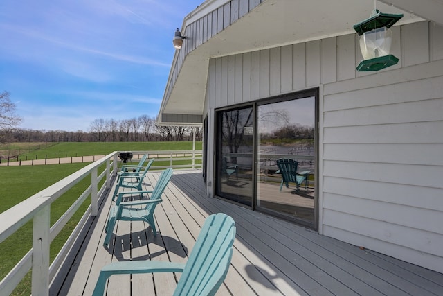 wooden terrace with a lawn