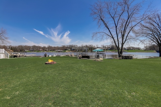 view of yard featuring a fire pit and a water view