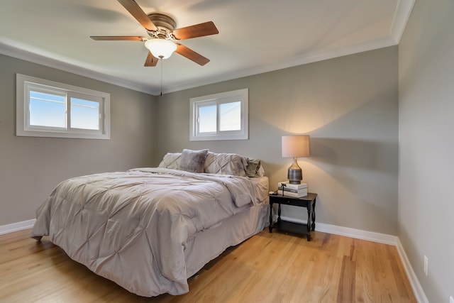 bedroom with crown molding, ceiling fan, and light wood-type flooring