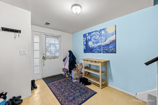 entryway with hardwood / wood-style flooring