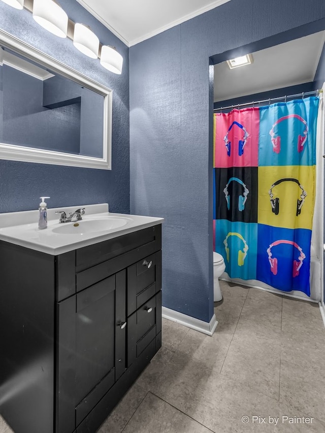 bathroom with vanity, toilet, walk in shower, and crown molding