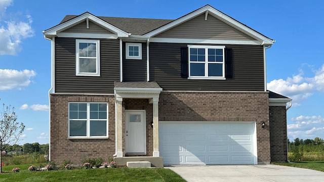 view of front facade featuring a front yard and a garage