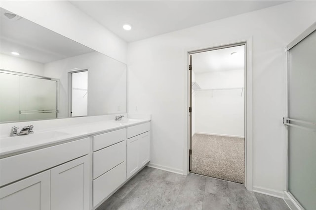 bathroom with walk in shower and vanity