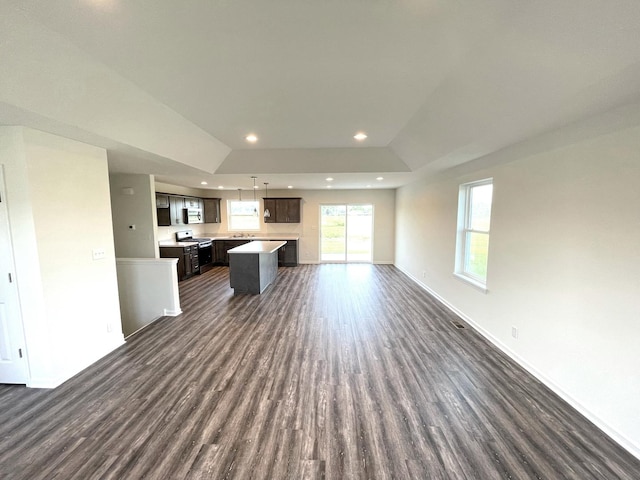 unfurnished living room with dark wood-type flooring