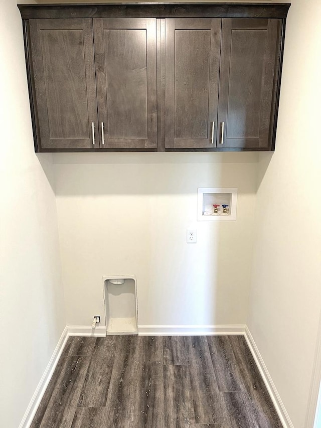 laundry room featuring gas dryer hookup, electric dryer hookup, cabinets, washer hookup, and dark hardwood / wood-style flooring