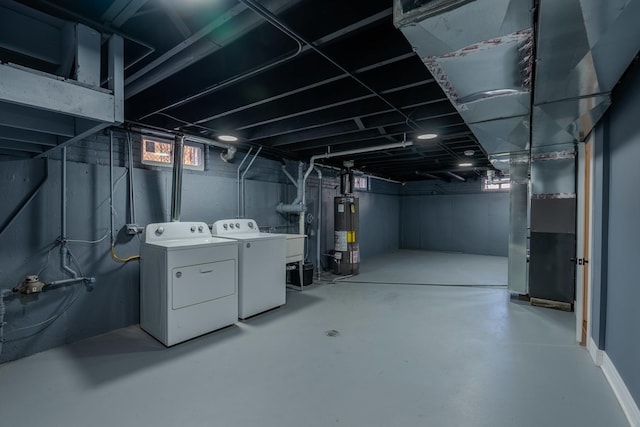 basement with separate washer and dryer and water heater