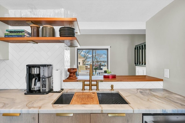 kitchen with sink, a textured ceiling, and dishwasher