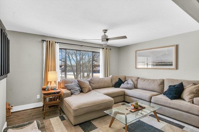 living room featuring ceiling fan and hardwood / wood-style floors