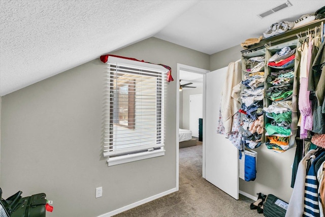 spacious closet featuring ceiling fan, carpet, and lofted ceiling