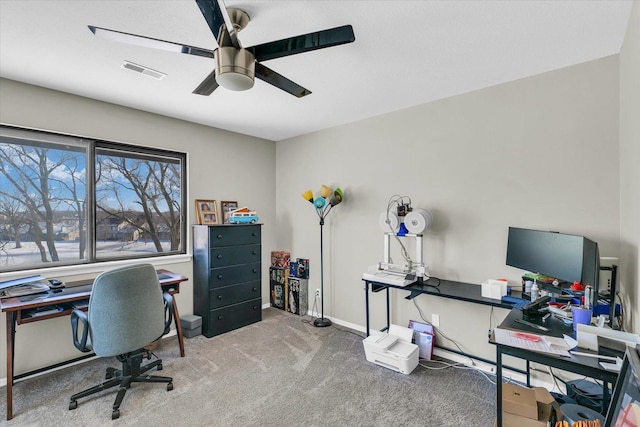 carpeted office featuring ceiling fan