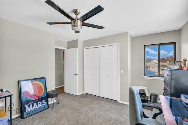 carpeted office space with ceiling fan