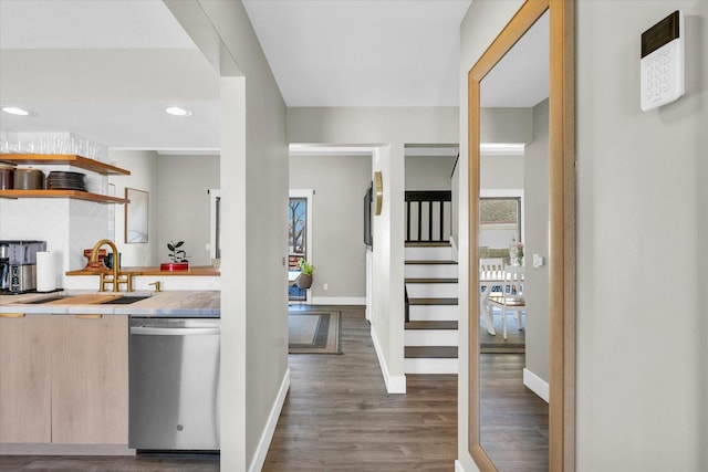 kitchen featuring tasteful backsplash, dishwasher, dark hardwood / wood-style floors, sink, and light brown cabinets