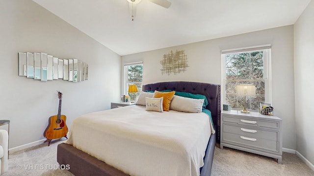 bedroom featuring ceiling fan, light colored carpet, and multiple windows