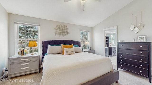 carpeted bedroom featuring ceiling fan, multiple windows, and lofted ceiling