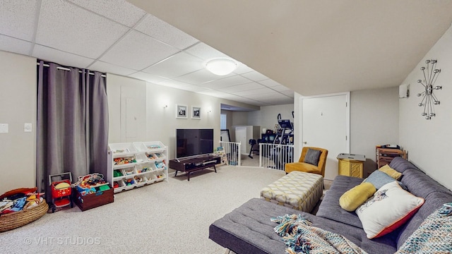 carpeted living room featuring a drop ceiling