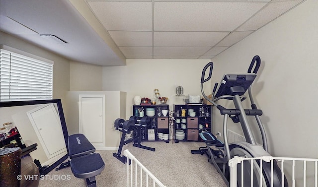 workout room with a drop ceiling and carpet flooring