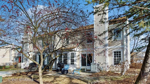 back of property featuring central air condition unit and a patio