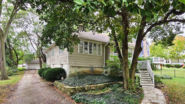 view of side of property featuring a garage and an outbuilding