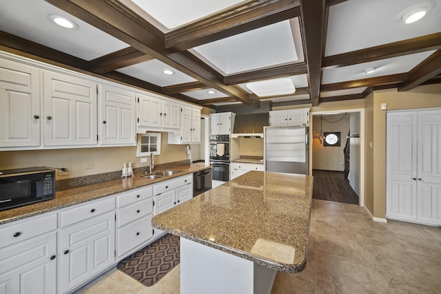 kitchen featuring white cabinetry, coffered ceiling, black appliances, and a center island