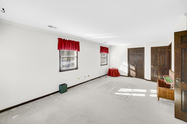 carpeted spare room with crown molding