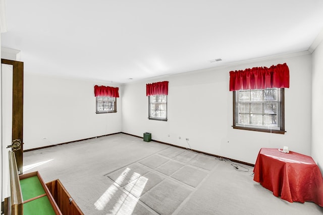 carpeted spare room featuring plenty of natural light