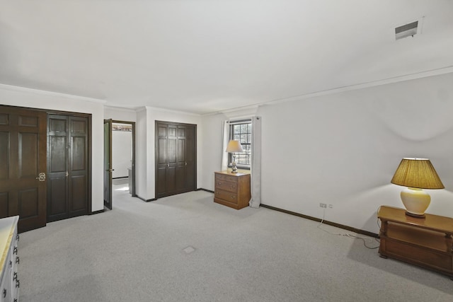 bedroom featuring crown molding, light colored carpet, and a closet