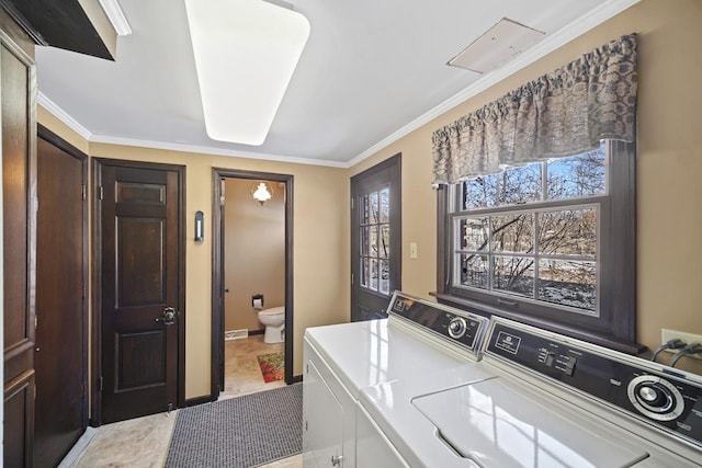 laundry room with ornamental molding and washer and dryer