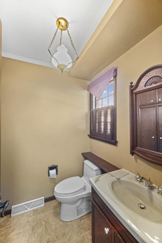 bathroom featuring crown molding, vanity, and toilet