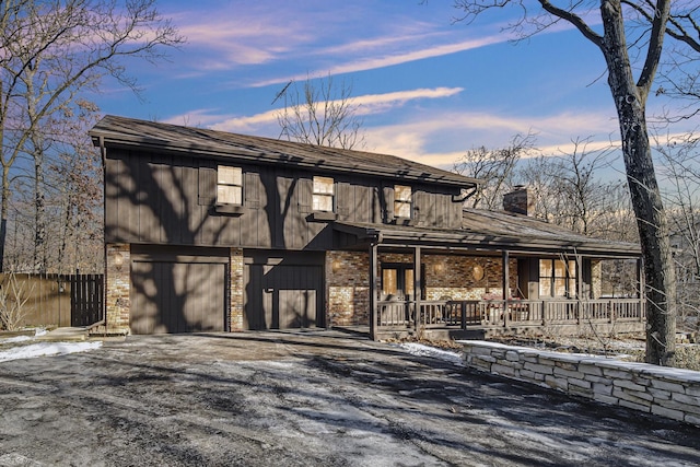 view of front facade with a garage and covered porch