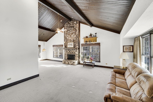 unfurnished living room with high vaulted ceiling, a fireplace, beamed ceiling, carpet, and wooden ceiling