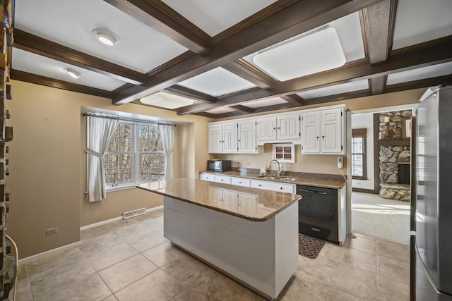 kitchen with sink, stainless steel fridge, dishwasher, a center island, and white cabinets